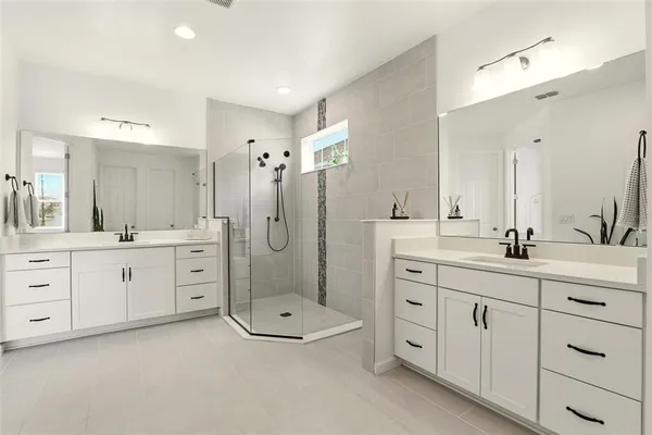 a bathroom with a sink double vanity granite toilet tub and shower