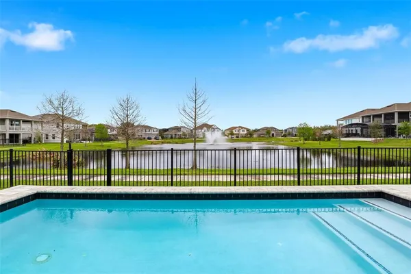 a view of house with a big yard and potted plants