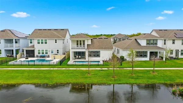 an aerial view of residential house with outdoor space and lake view