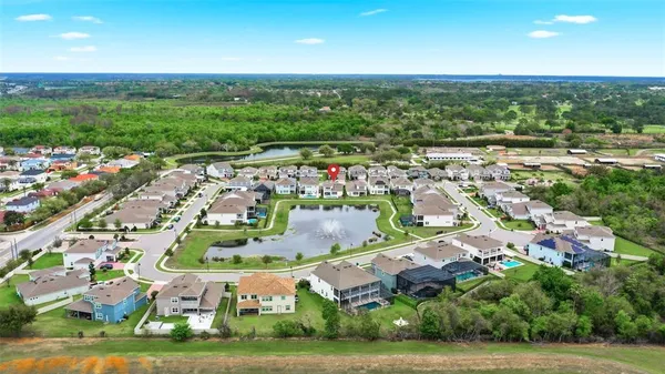 an aerial view of residential houses with outdoor space and street view