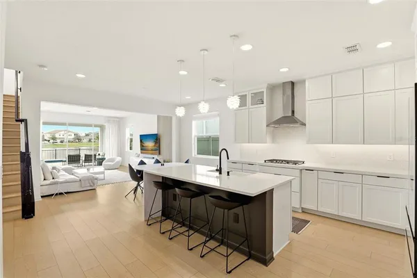 a kitchen with a sink stove and cabinets