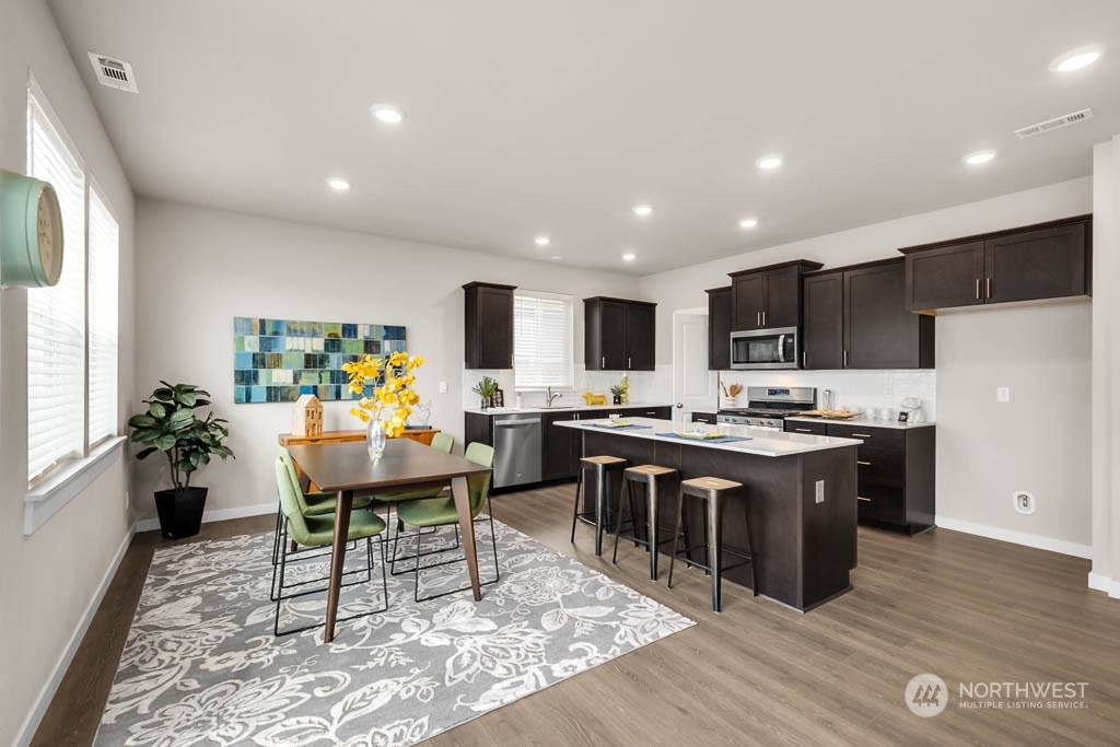 2902 Longhorn Loop, Unit 246 Ellensburg, WA 98926 - Photo 12 of 30 a living room with stainless steel appliances kitchen island granite countertop furniture wooden floor and a view of kitchen