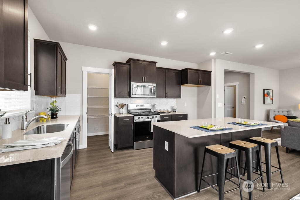 2902 Longhorn Loop, Unit 246 Ellensburg, WA 98926 - Photo 17 of 30 a kitchen with stainless steel appliances kitchen island granite countertop a dining table and chairs