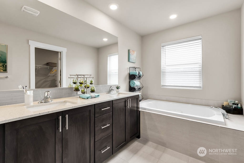 2902 Longhorn Loop, Unit 246 Ellensburg, WA 98926 - Photo 23 of 30 a bathroom with a tub sink double vanity granite and mirror