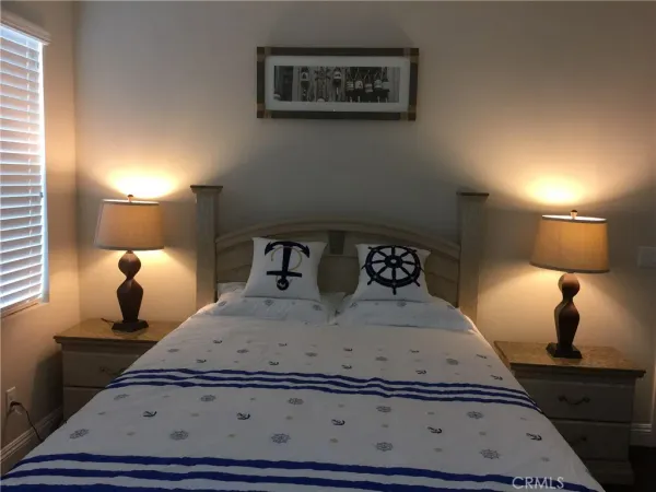 a bedroom with a bed and a lamp