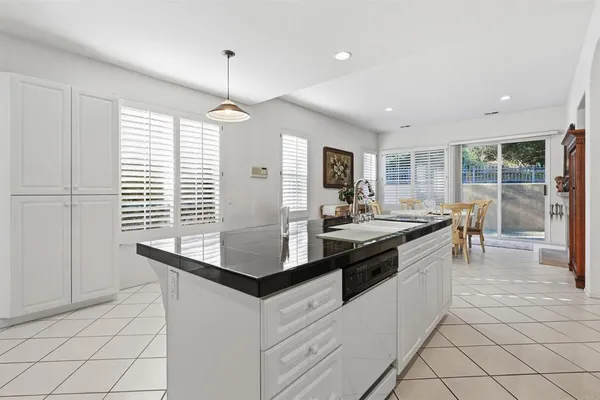 a kitchen with stainless steel appliances granite countertop a sink and a stove
