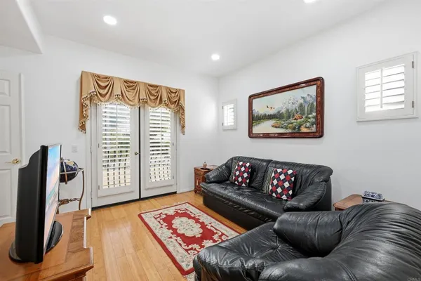 a living room with furniture a couch and a flat screen tv