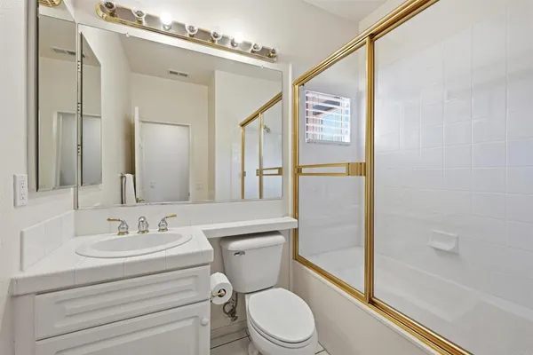 a bathroom with a toilet a sink and a shower