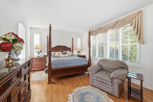 a bedroom with furniture and a large window