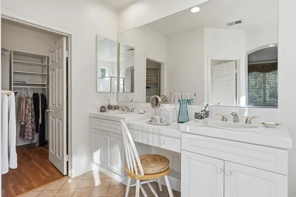 a en suite bathroom with a double vanity sink double and a mirror