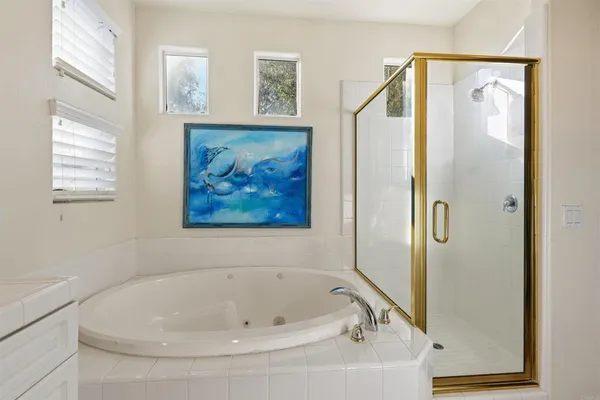 a bathroom with a tub and a shower