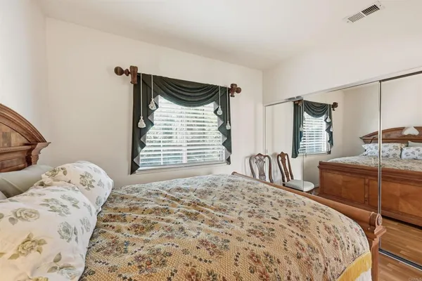 a bedroom with a large bed and a dresser