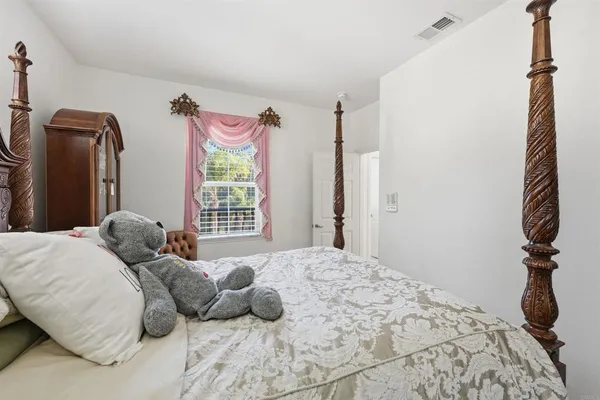 a bedroom with a bed and a window