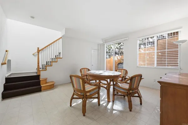 a dining room with furniture and window