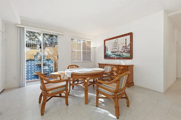 a dining room with furniture and window