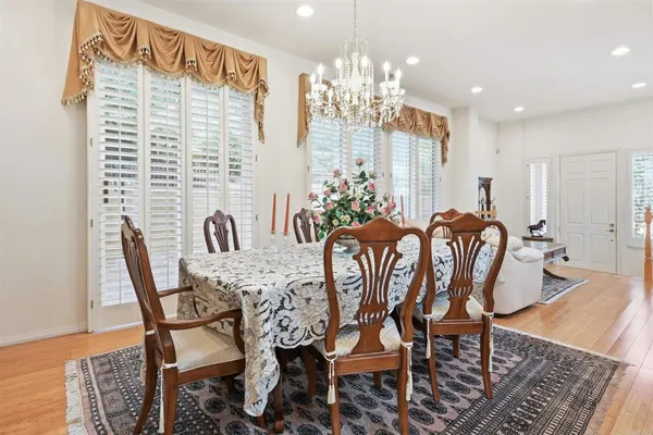 a view of a dining room with furniture and chandelier