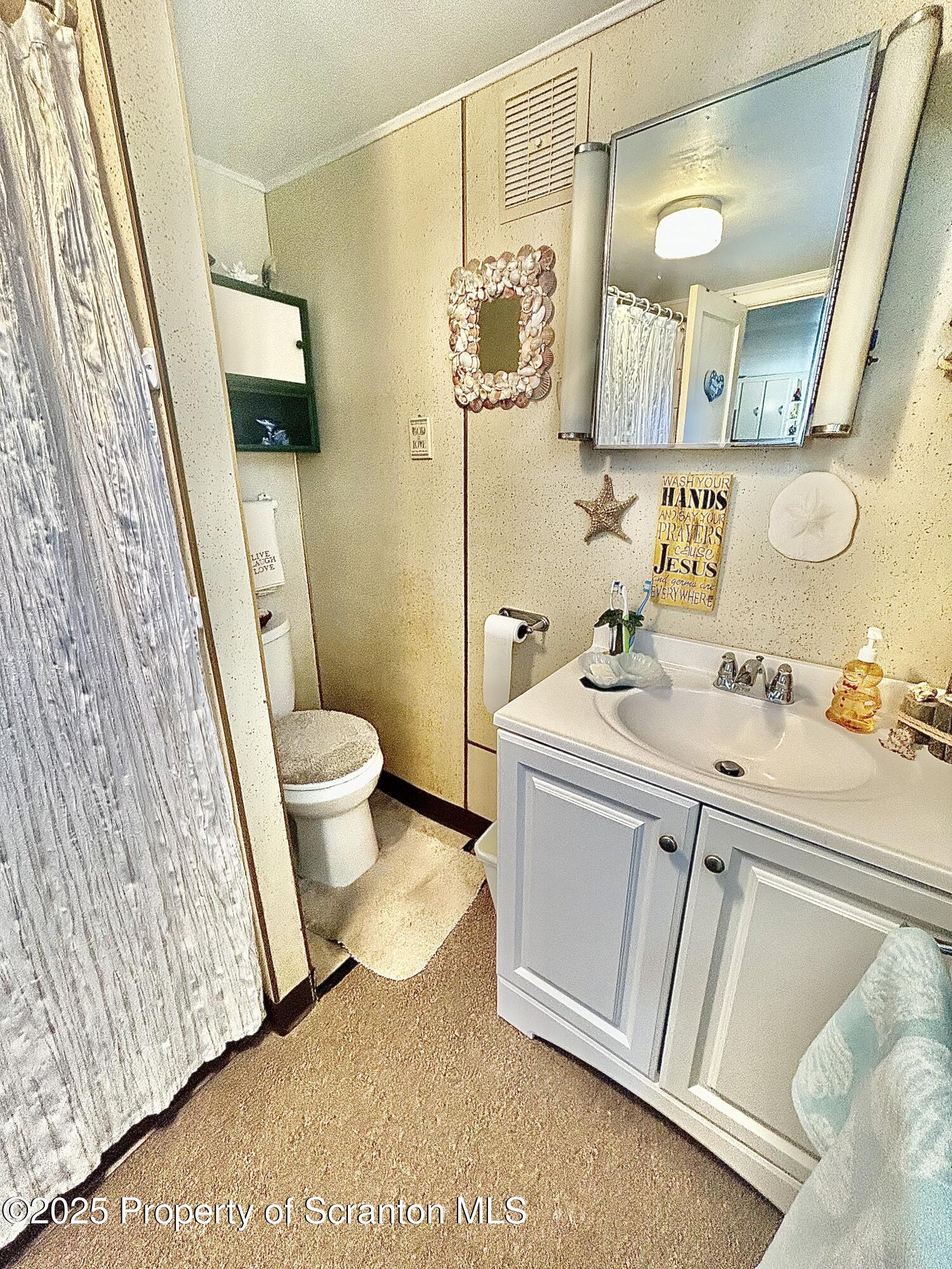 166 State Rte 2005 Springville, PA 18844 - Photo 16 of 44 a bathroom with a sink and mirror with toilet