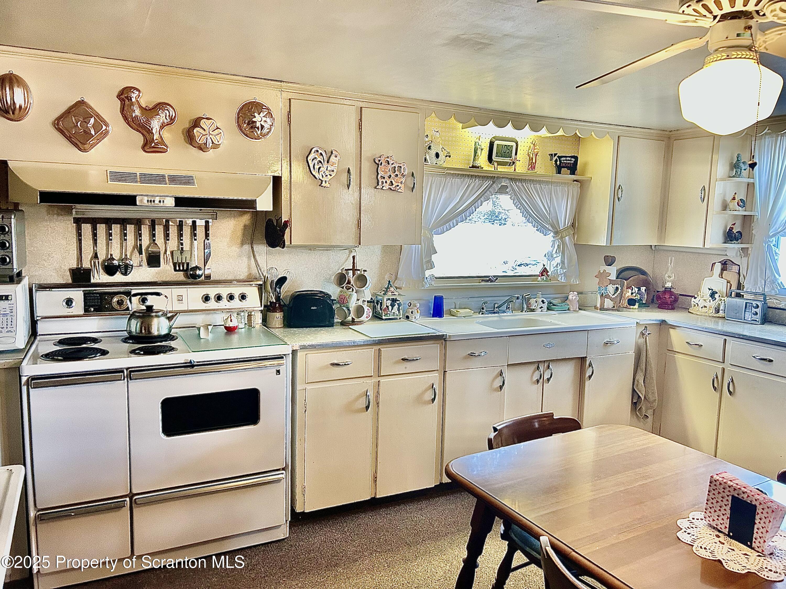 166 State Rte 2005 Springville, PA 18844 - Photo 5 of 44 a kitchen with a stove a sink and cabinets