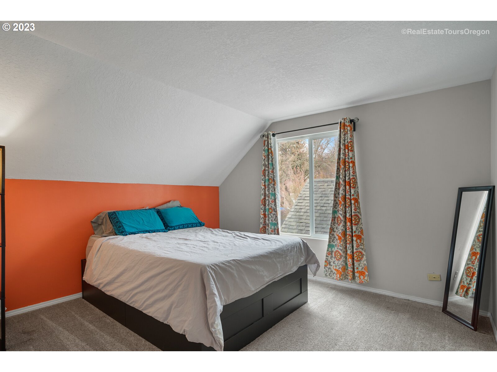 7325 Southwest 158th Place Beaverton, OR 97007 - Photo 15 of 28 a bedroom with a bed and a flat tv screen on dresser