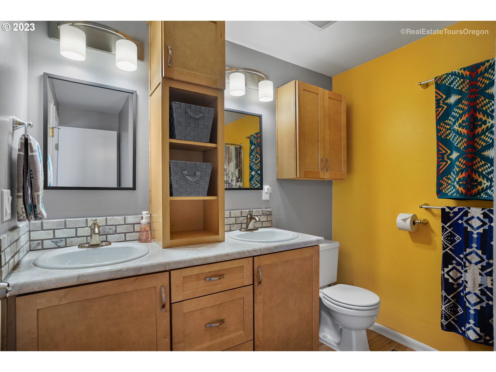 7325 Southwest 158th Place Beaverton, OR 97007 - Photo 17 of 28 a bathroom with a toilet a sink a vanity a mirror and shower curtain