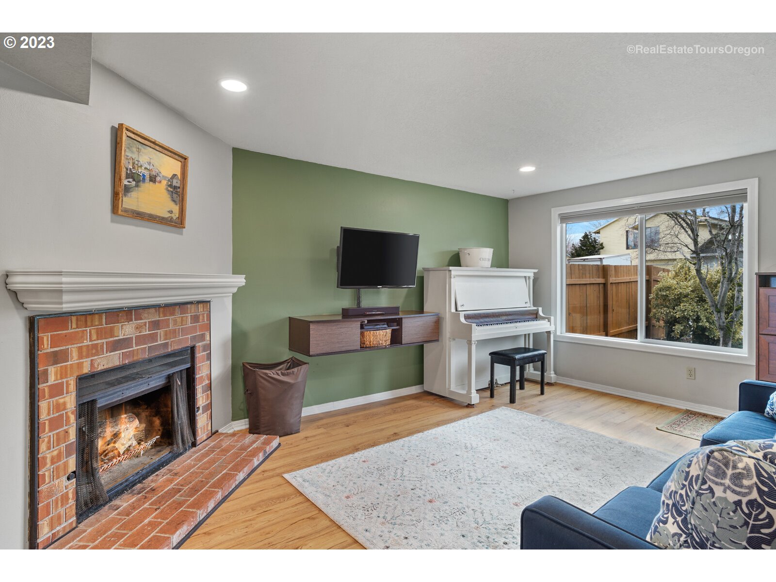 7325 Southwest 158th Place Beaverton, OR 97007 - Photo 2 of 28 a living room with furniture a flat screen tv and a fireplace