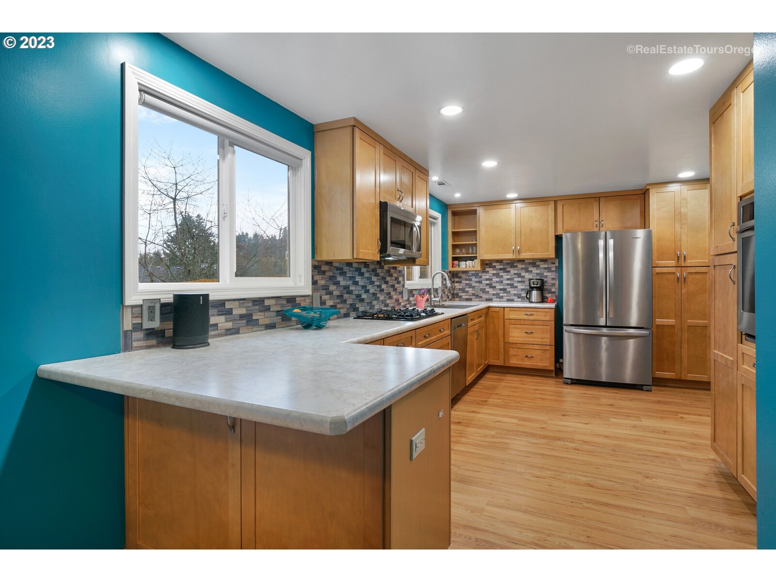 7325 Southwest 158th Place Beaverton, OR 97007 - Photo 6 of 28 a kitchen with stainless steel appliances granite countertop a sink a stove and a refrigerator