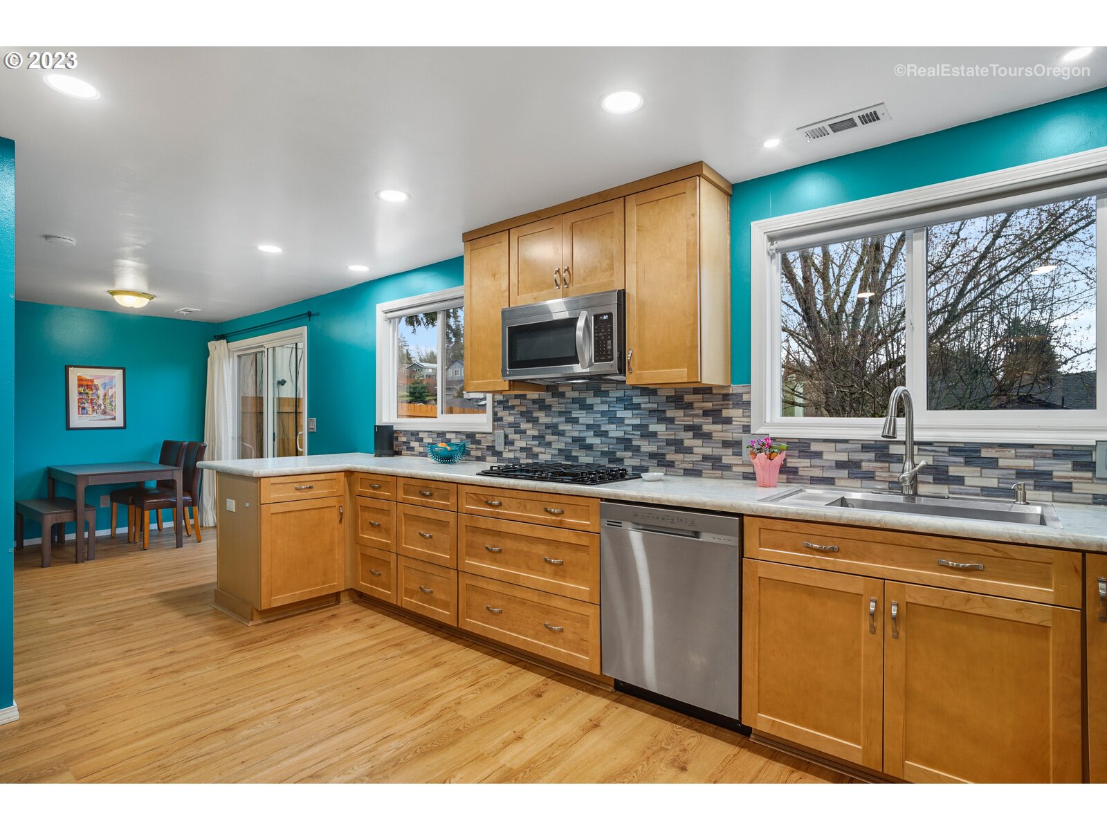 7325 Southwest 158th Place Beaverton, OR 97007 - Photo 9 of 28 a large kitchen with kitchen island granite countertop a large window and stainless steel appliances