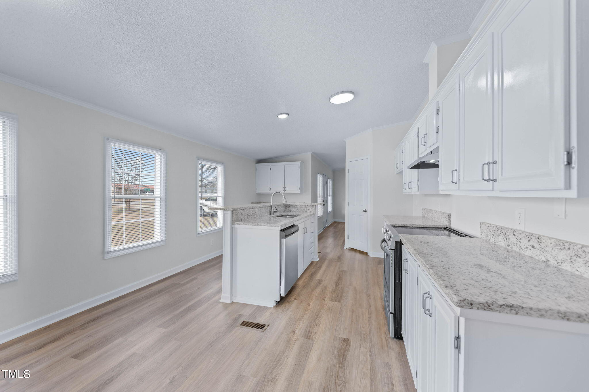 927 Stanley Chapel Church Road Mount Olive, NC 28365 - Photo 10 of 34 a kitchen with granite countertop white cabinets and white appliances
