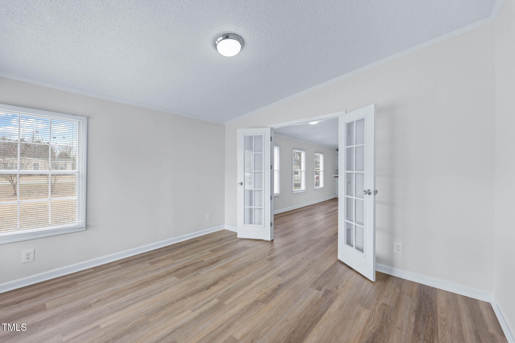 927 Stanley Chapel Church Road Mount Olive, NC 28365 - Photo 15 of 34 an empty room with wooden floor and windows