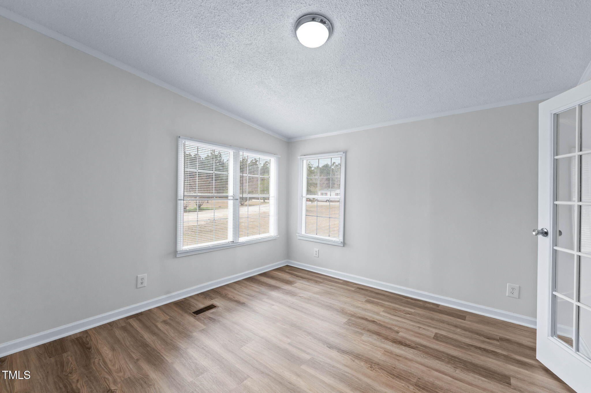 927 Stanley Chapel Church Road Mount Olive, NC 28365 - Photo 16 of 34 an empty room with wooden floor and windows