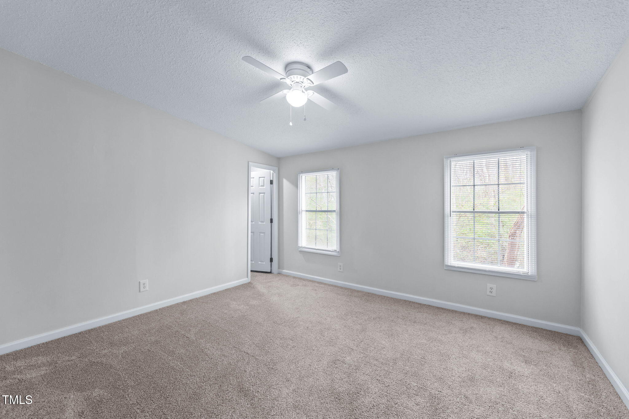 927 Stanley Chapel Church Road Mount Olive, NC 28365 - Photo 20 of 34 an empty room with windows and chandelier fan