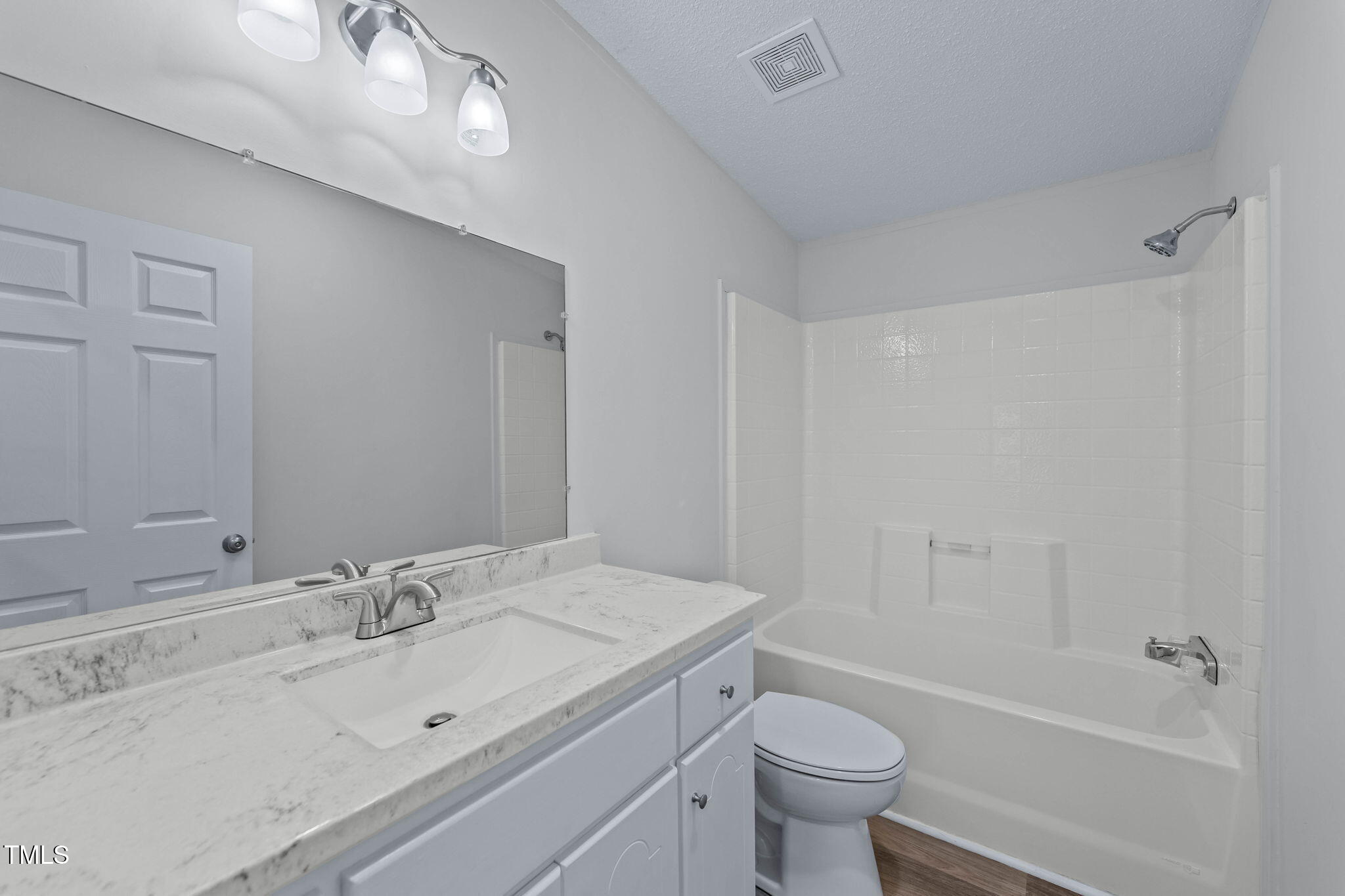 927 Stanley Chapel Church Road Mount Olive, NC 28365 - Photo 24 of 34 a bathroom with a sink a toilet and a large mirror