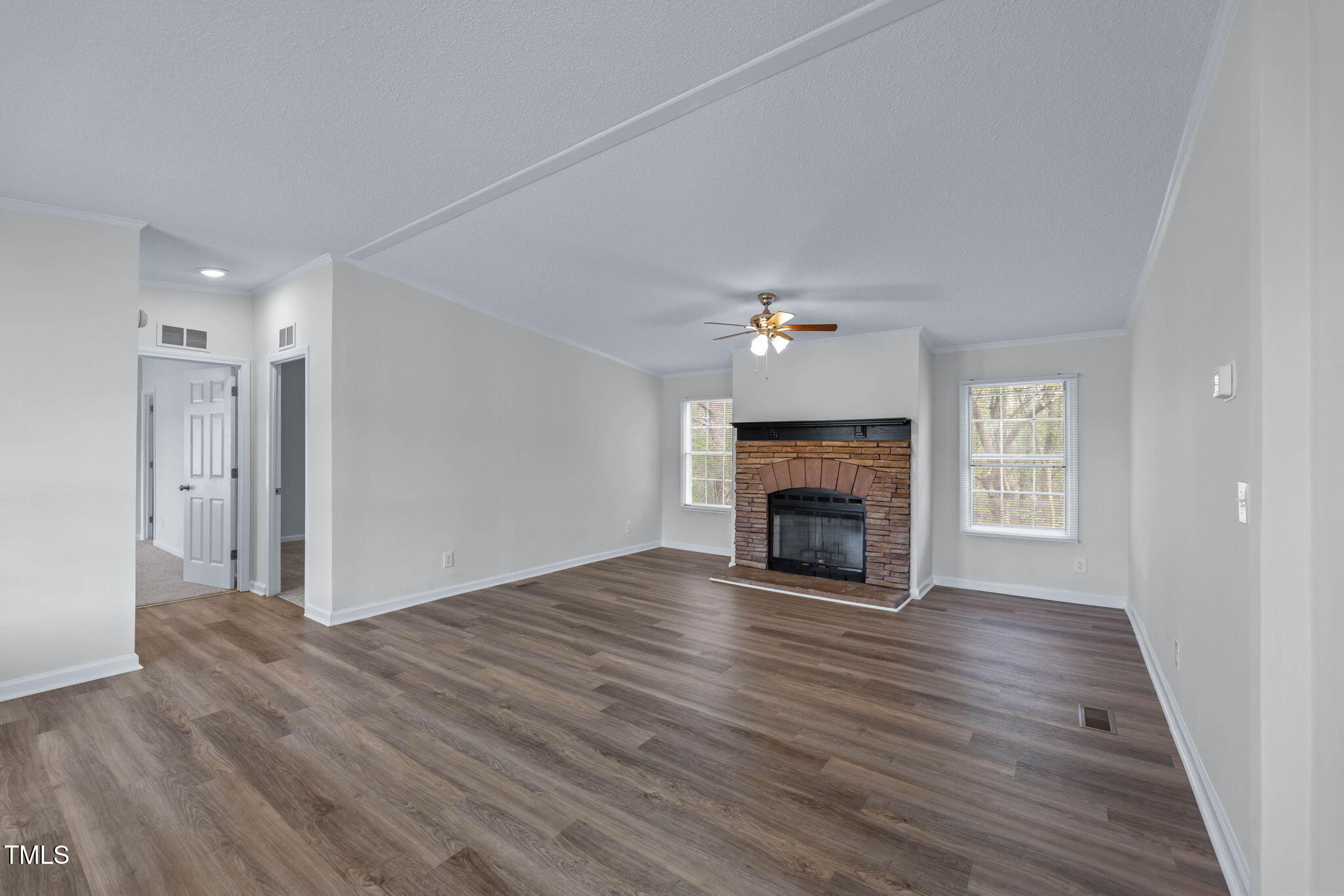 927 Stanley Chapel Church Road Mount Olive, NC 28365 - Photo 2 of 34 a view of an empty room with wooden floor fireplace and a window