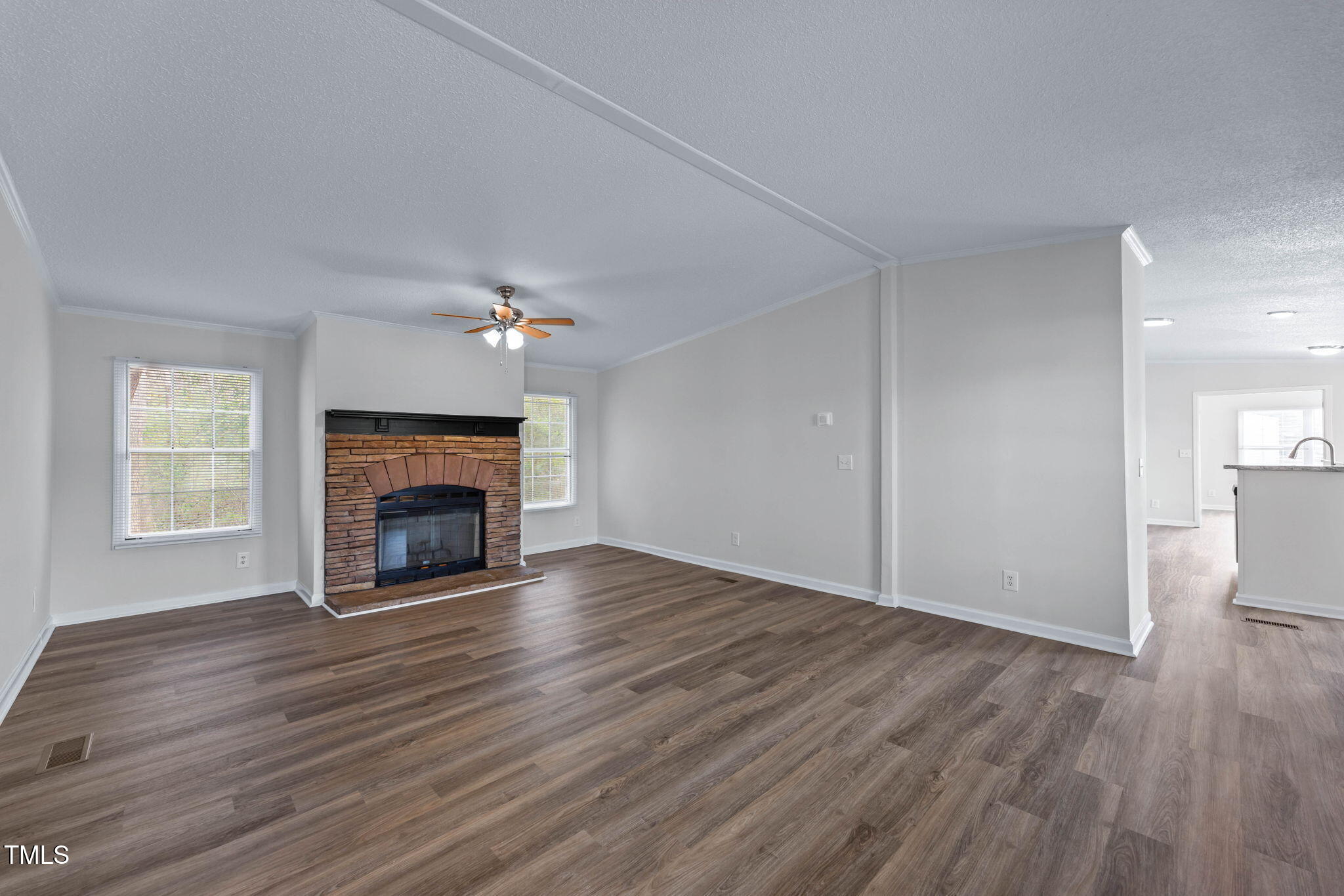 927 Stanley Chapel Church Road Mount Olive, NC 28365 - Photo 3 of 34 a view of an empty room with wooden floor fireplace and a window