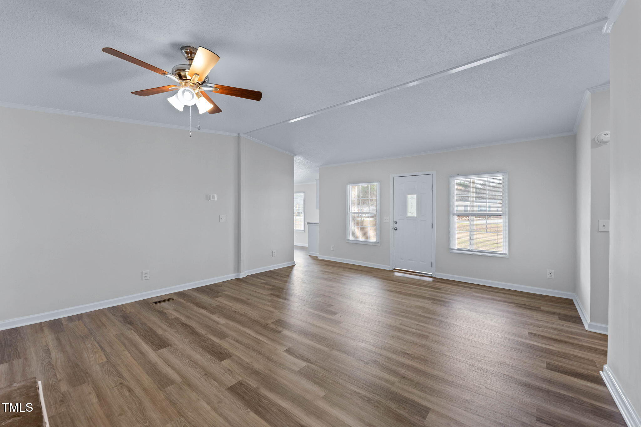 927 Stanley Chapel Church Road Mount Olive, NC 28365 - Photo 5 of 34 an empty room with wooden floor fan and windows