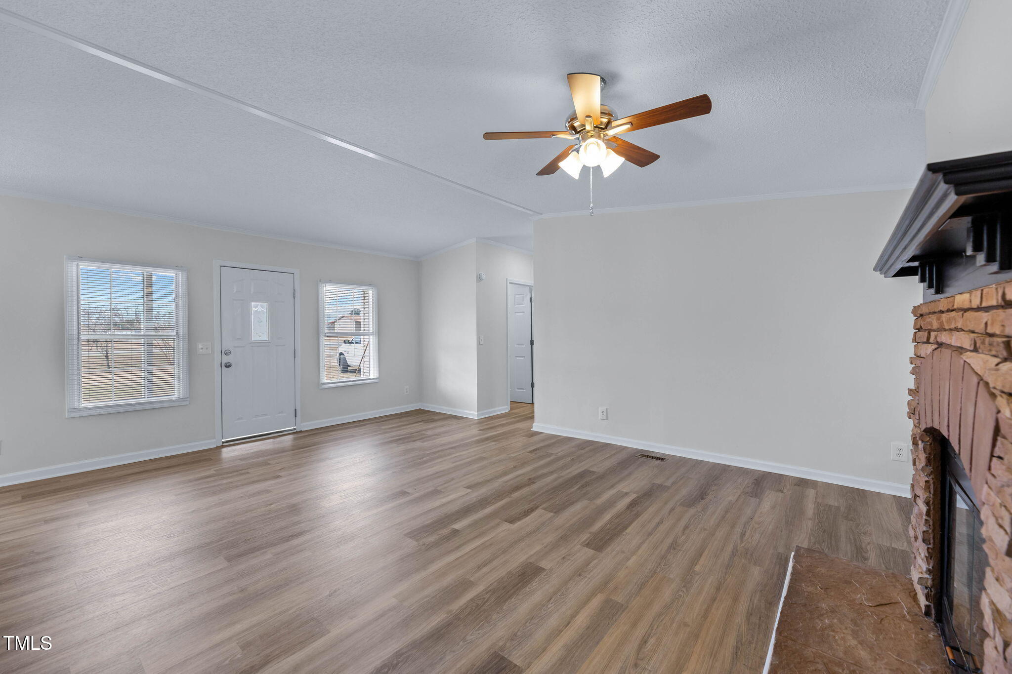 927 Stanley Chapel Church Road Mount Olive, NC 28365 - Photo 6 of 34 a view of empty room with wooden floor and fan