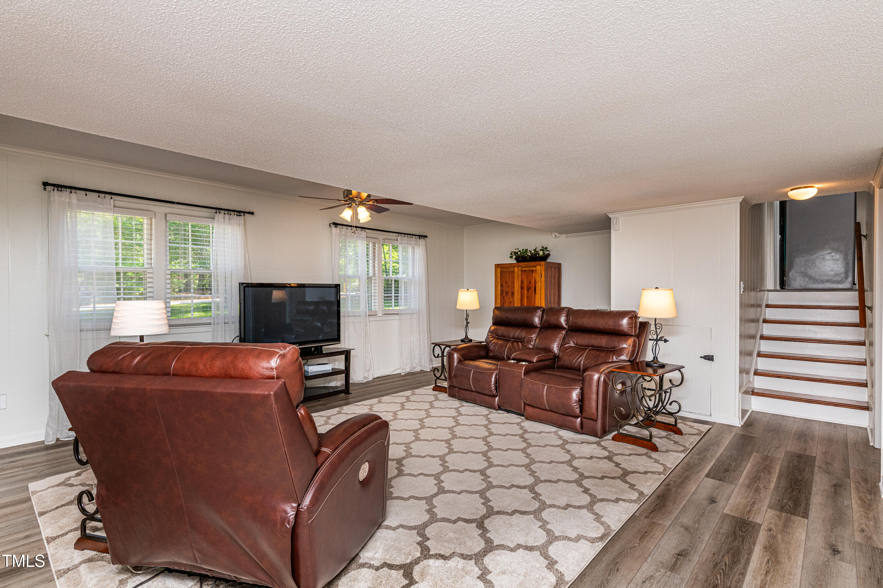 3301 Manor Ridge Drive Raleigh, NC 27603 - Photo 6 of 38 a living room with furniture a flat screen tv and a fireplace