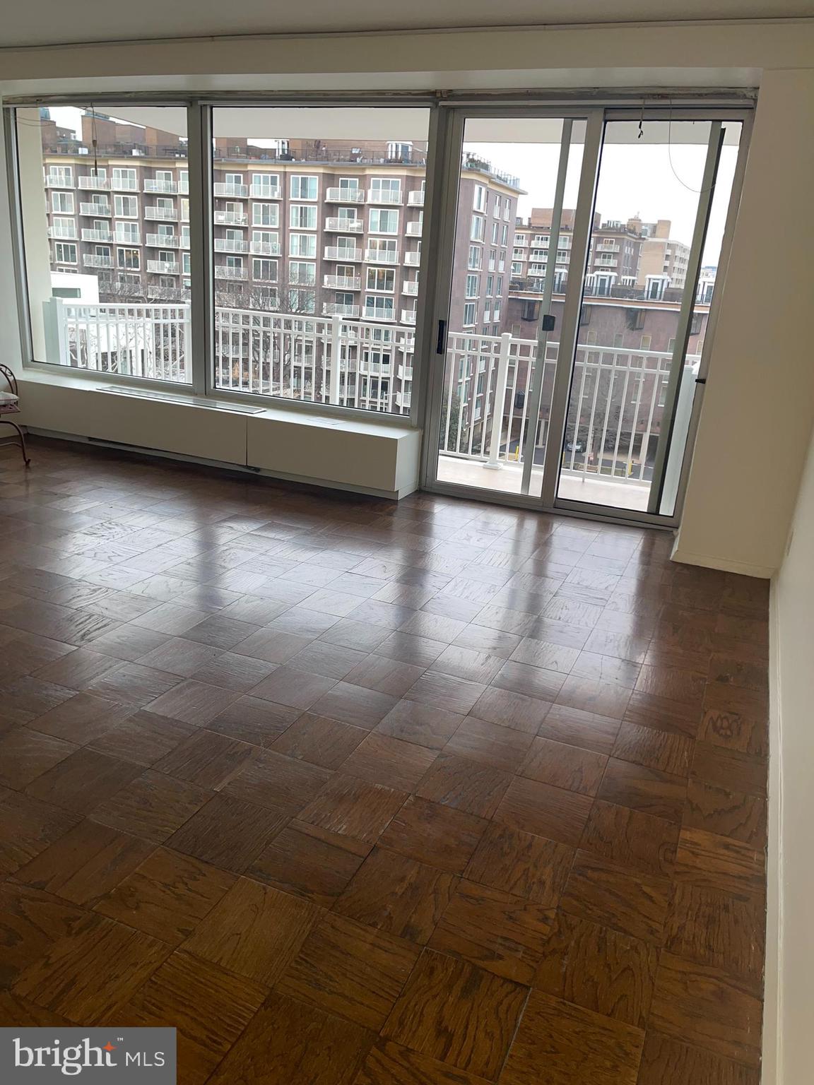 1425 4th Street Southwest, Unit A502 Washington, DC 20024 - Photo 18 of 51 a view of an empty room with wooden floor and a window