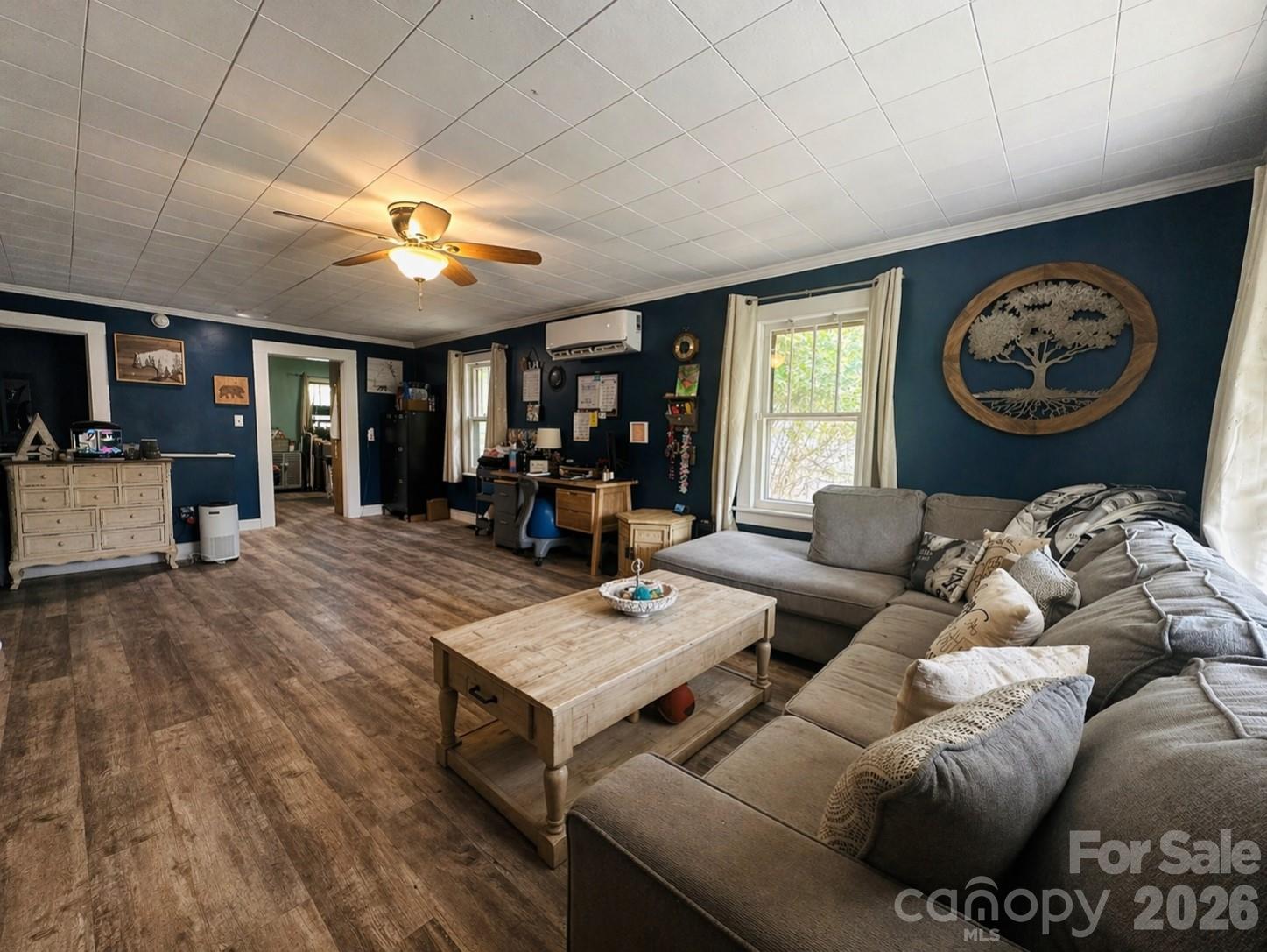 104 Old Fort Road Fairview, NC 28730 - Photo 4 of 17 a living room with furniture a clock on wall and a large window
