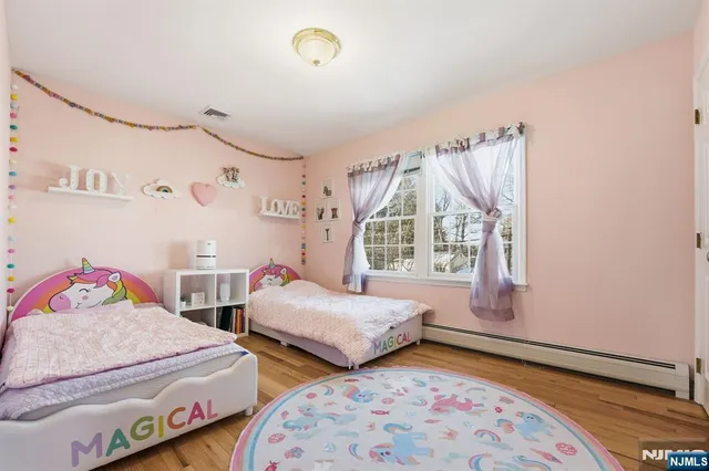 a bedroom with two beds and a window