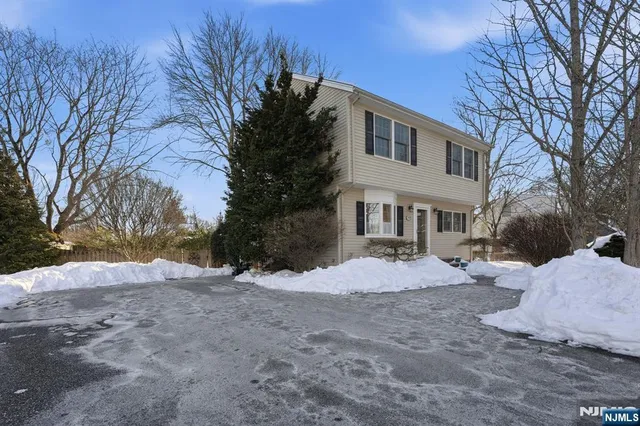 a view of a house with a yard covered in snow