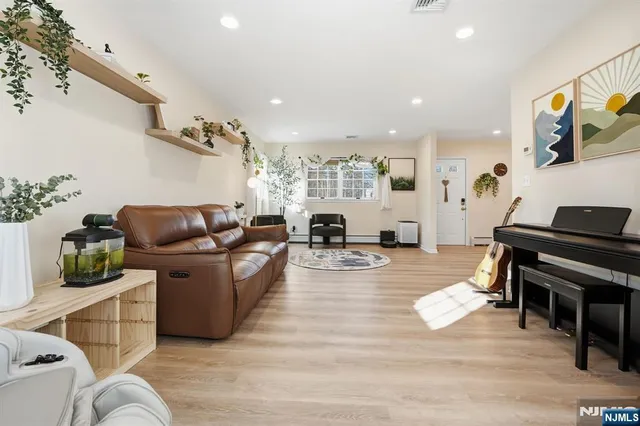 a living room with furniture and a piano