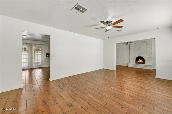 a view of empty room with wooden floor