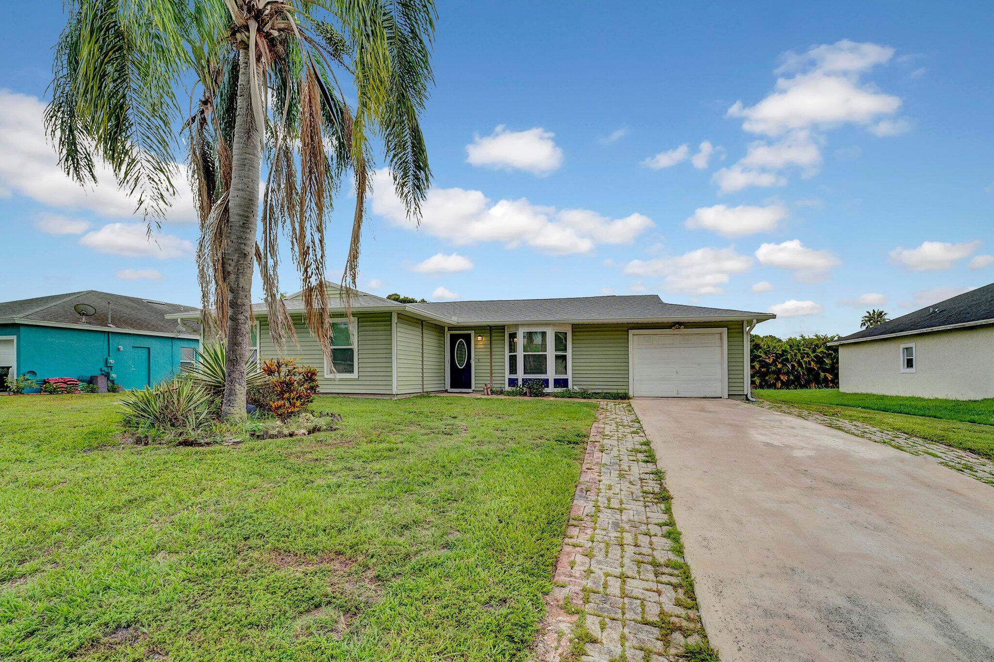 1918 Southeast Cheltenham Street Port St. Lucie, FL 34983 - Photo 2 of 15 1918 front