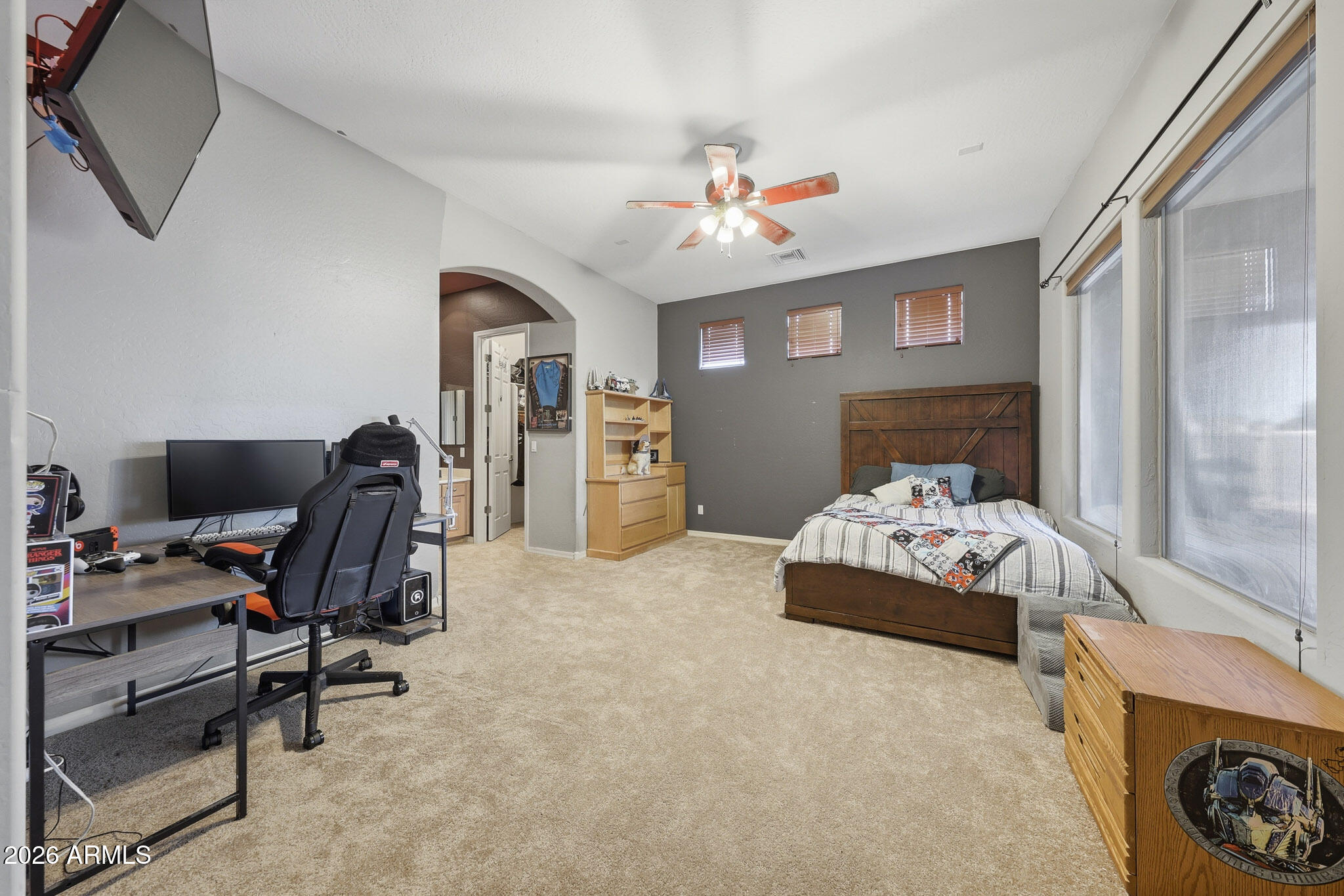 23024 West Sierra Ridge Way Wittmann, AZ 85361 - Photo 16 of 99 a bedroom with a bed and a chandelier