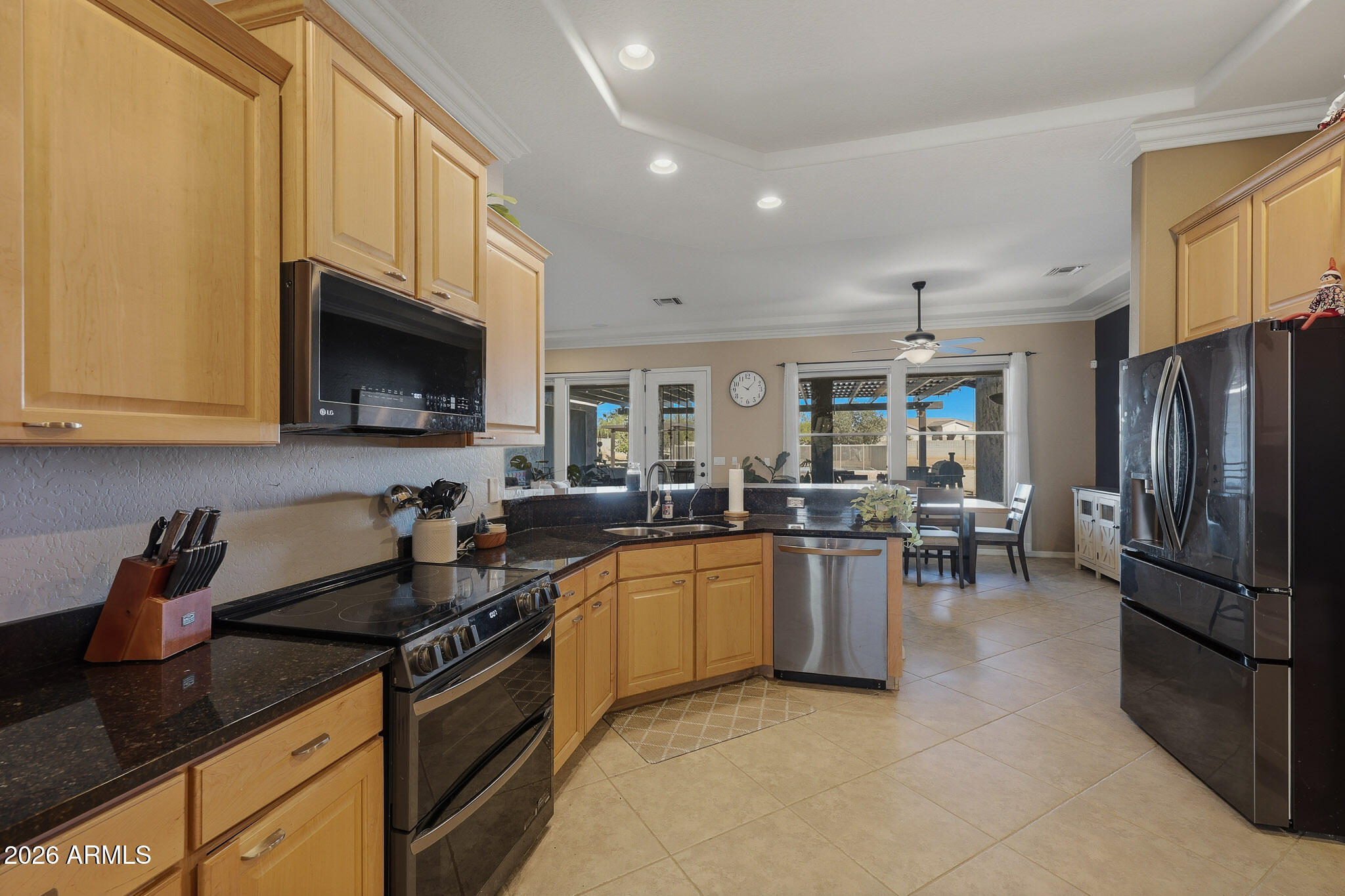 23024 West Sierra Ridge Way Wittmann, AZ 85361 - Photo 33 of 99 a kitchen with stainless steel appliances granite countertop a sink dishwasher stove top oven and refrigerator