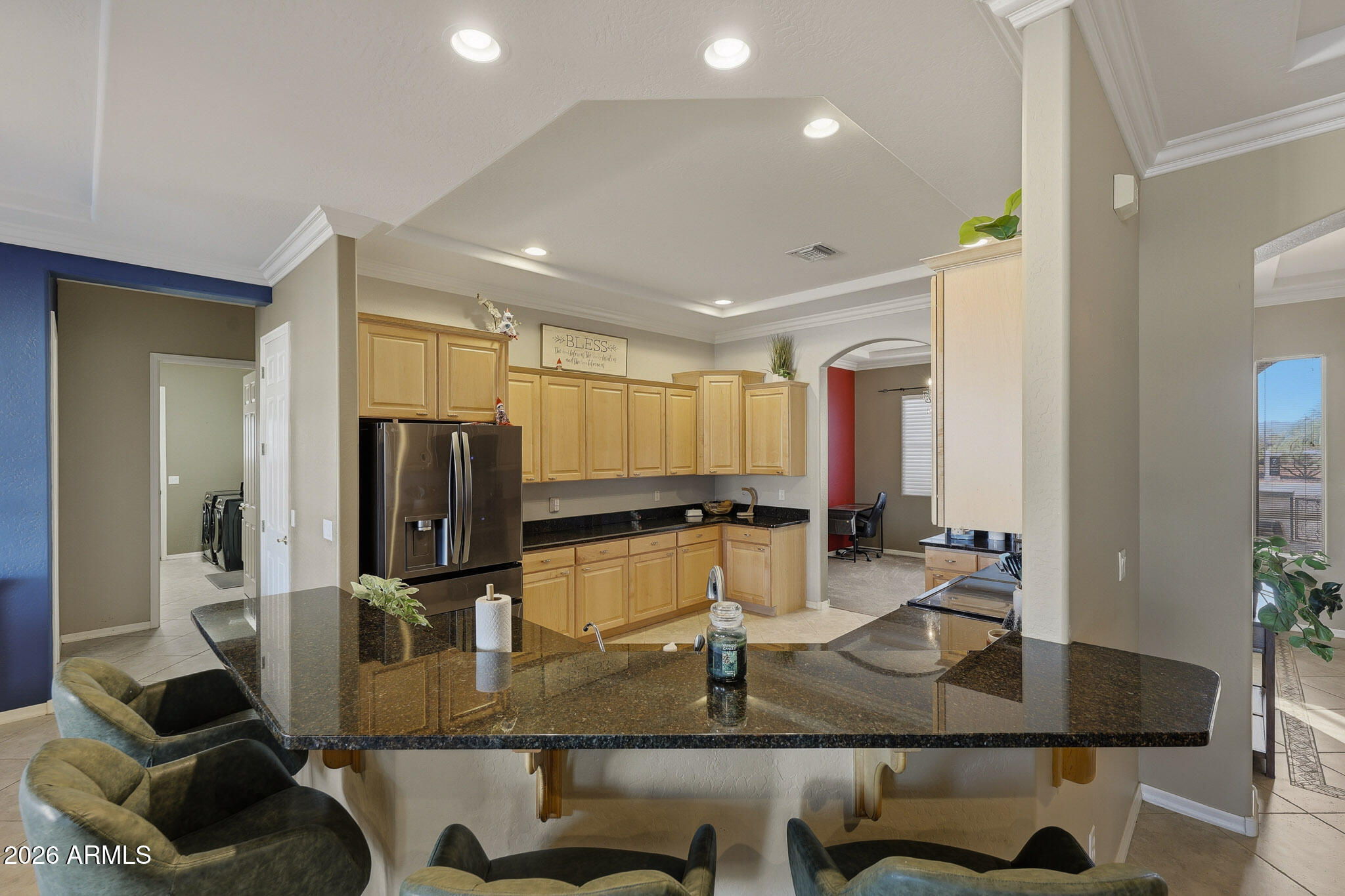 23024 West Sierra Ridge Way Wittmann, AZ 85361 - Photo 35 of 99 a kitchen with stainless steel appliances granite countertop a refrigerator and a counter top space
