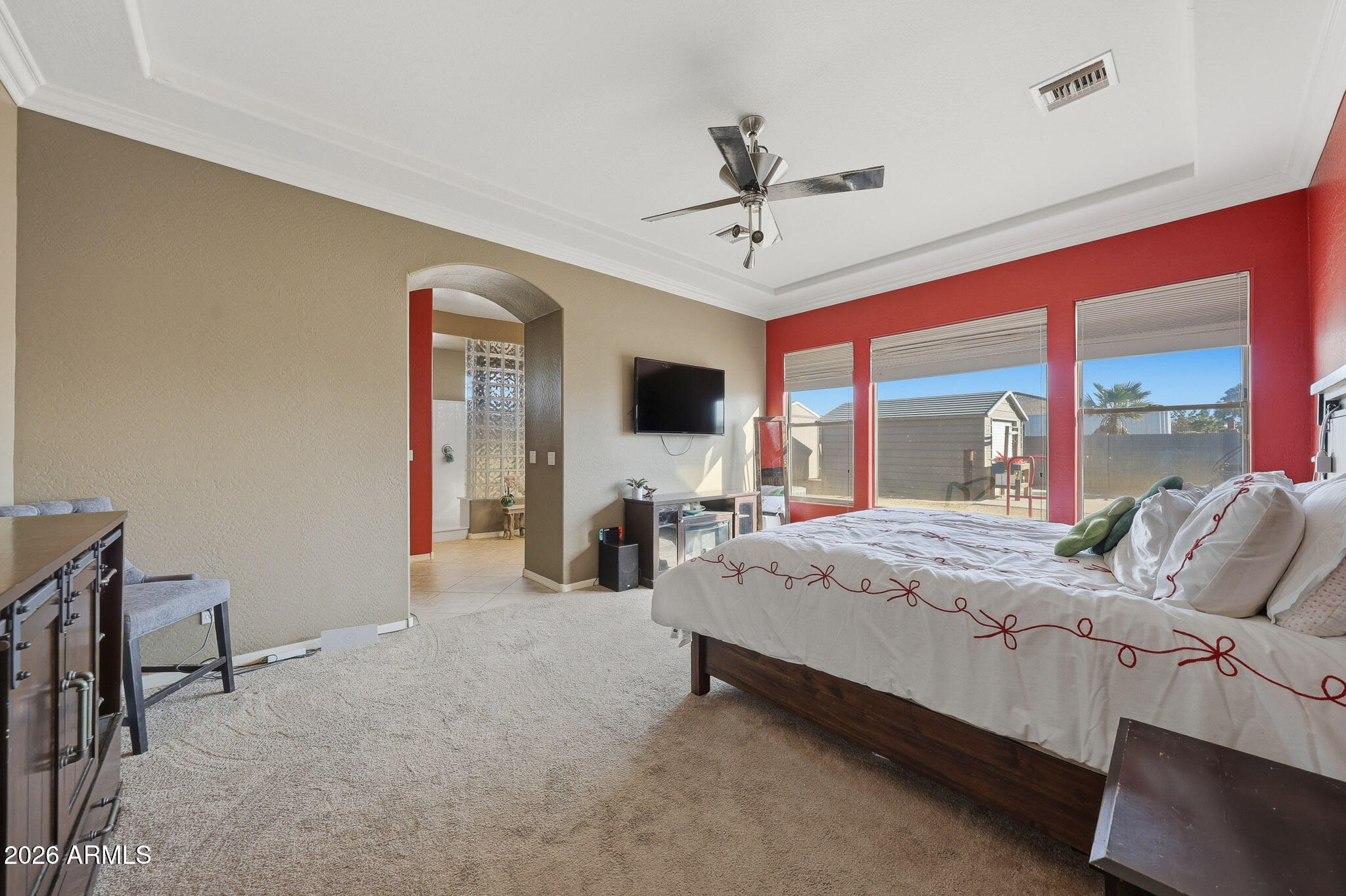 23024 West Sierra Ridge Way Wittmann, AZ 85361 - Photo 39 of 99 a bedroom with a bed a large window and flat screen tv