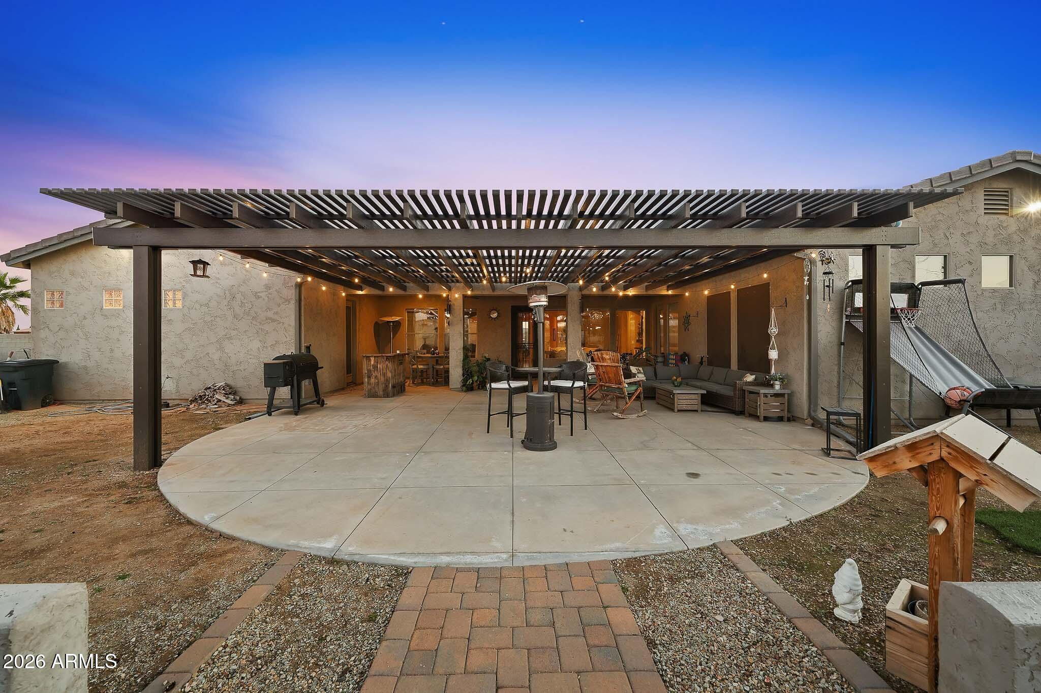 23024 West Sierra Ridge Way Wittmann, AZ 85361 - Photo 84 of 99 a view of a swimming pool with outdoor seating