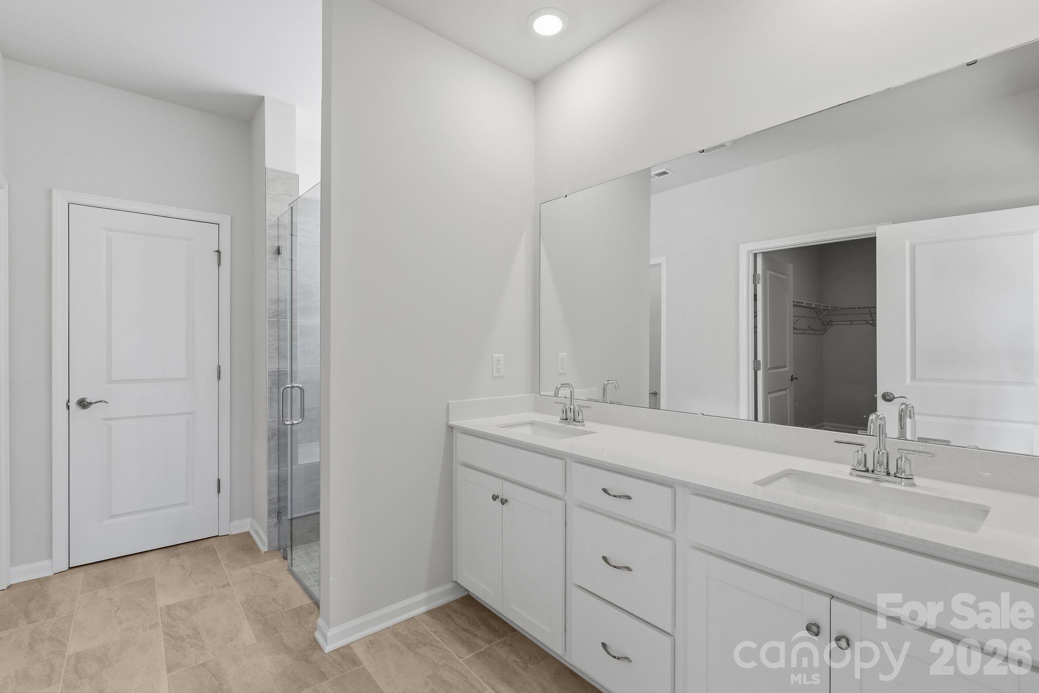 5475 Redbud Road, Unit 57 Lancaster, SC 29720 - Photo 25 of 30 a bathroom with double sink and a mirror